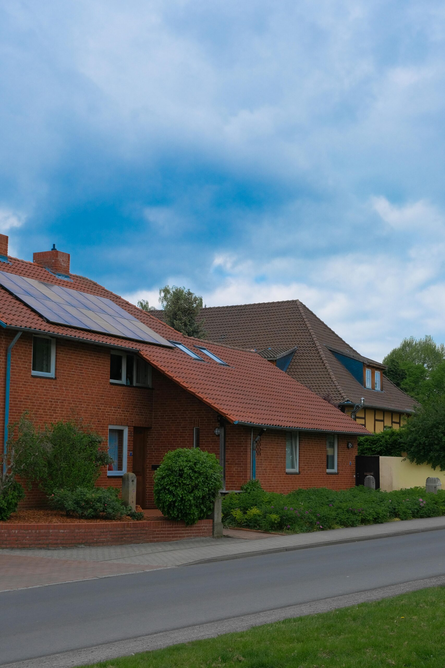 Modern American home with solar panels and green landscaping